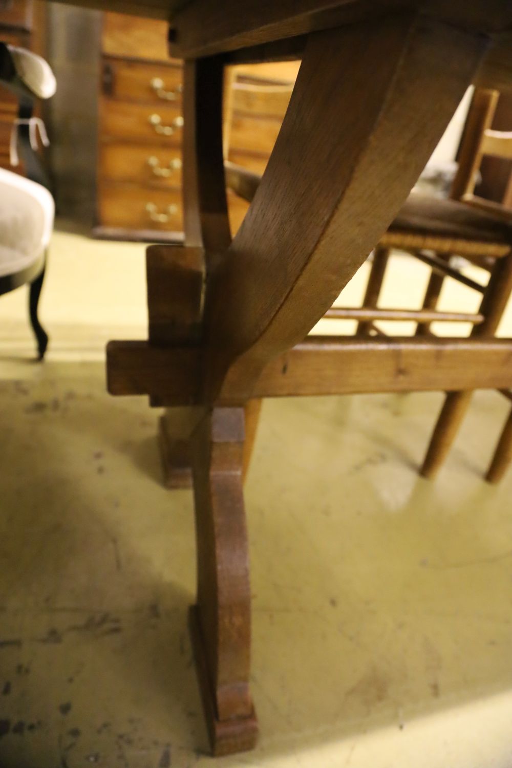 A 17th century style oak refectory table on X-frame supports, width 224cm, depth 70cm, height 74cm